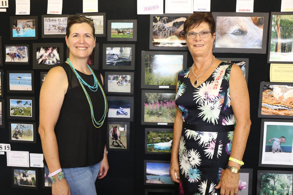 Destination Southern Downs marketing manager Izelle Barnard and photography steward Janet Platz admire the amazing entries in the photography section in the Douglas Feez Pavillion.